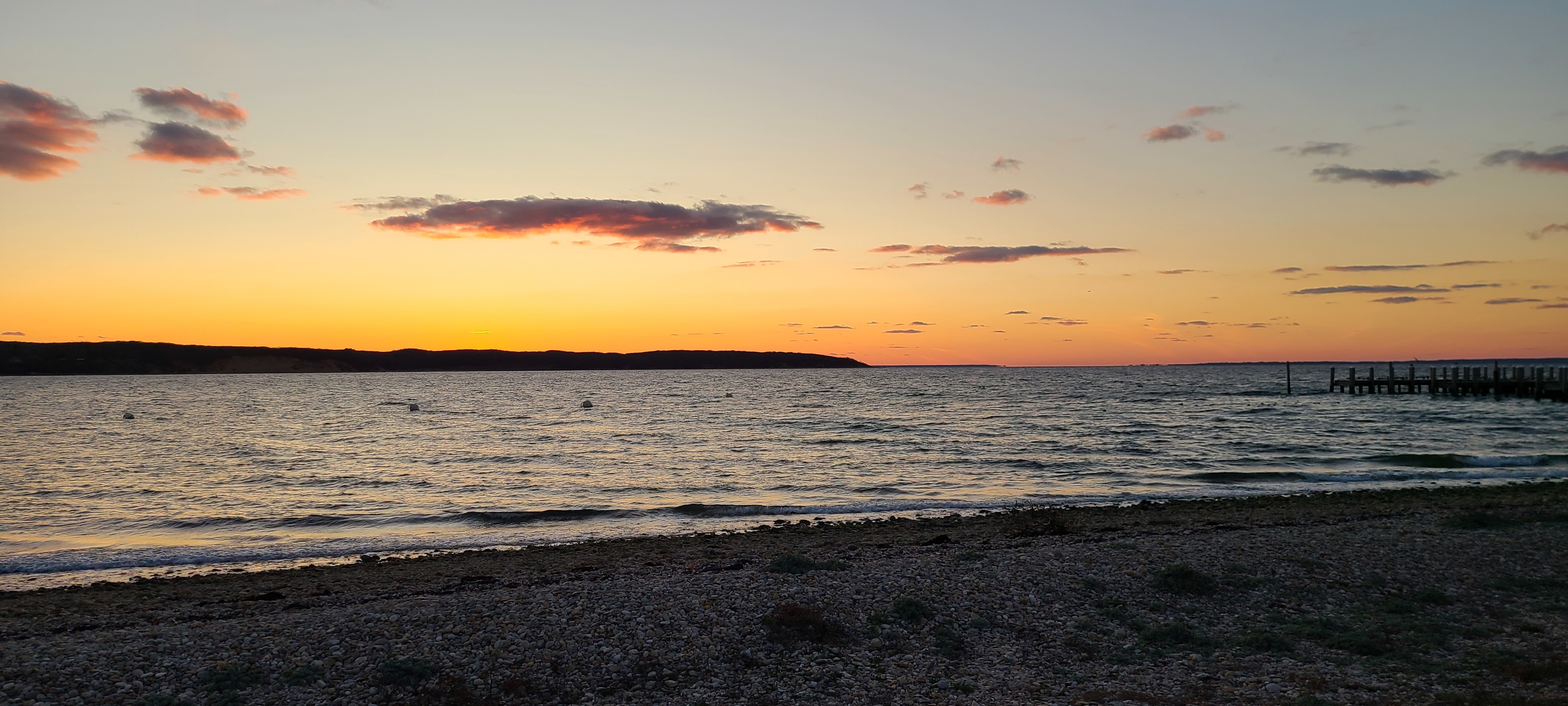 Sunset over an inlet in Montauk N.Y., with a bit of beach visible in the foreground; taken 11/14/2020